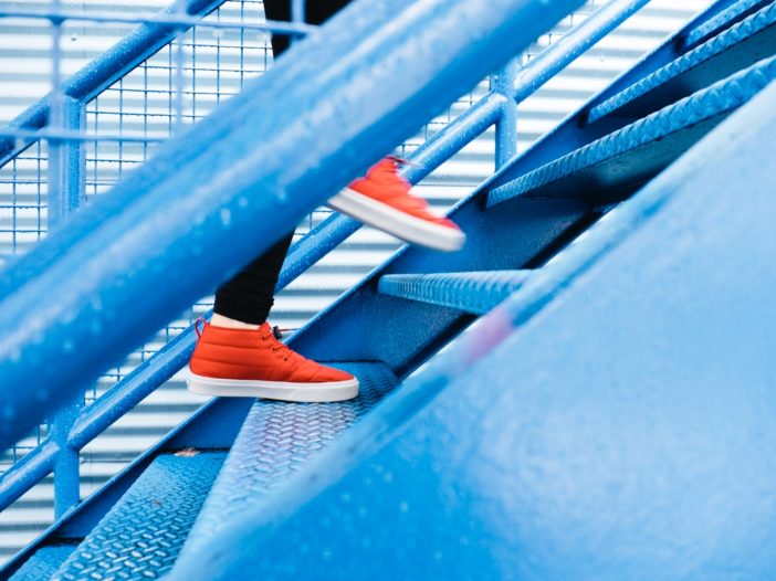 person stepping on blue stairs